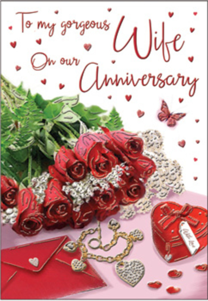 In this richly detailed anniversary card, the composition unfolds like an elegant vignette from a romantic home in West Hampstead. A bouquet of classic red roses dominates the centre, each flower luxuriously full, petals layered in generous, velvety curves that convey warmth and steadiness. The roses are gathered together in a graceful cluster, partly wrapped and framed by lush greens that arc and weave around them, creating a sense of lavish abundance. The greens contrast beautifully with the deep red tones, adding dimension and movement, almost like the gentle sway of branches in nearby Fortune Green. Alongside the bouquet, a vivid red box, reminiscent of a treasured jewellery case, sits proudly, its surface smooth and gently reflective. Nearby lies a jewellery set, catching glimmers of light along polished metal and faceted stones, suggesting years of exchanged gifts and quiet moments of appreciation. Fine lace-like detailing and delicate heart motifs are scattered around the scene, adding softness and romantic texture to the background. A neatly placed envelope hints at a heartfelt message concealed inside, ready to be opened on a special anniversary morning. The colour palette is rich-crimson reds, warm blushes, greens, and hints of gold and silver-evoking the cosiness of West Hampstead's residential streets at dusk. Every element feels intentionally placed, as if arranged by a skilled florist who understands the language of flowers and love. The overall mood is embracing and nostalgic, perfect for marking an anniversary filled with shared memories and gentle promises.